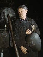 Welder at the C & NW RR locomotive shops, 40th Street shops, Chicago, Ill., 1942. Creator: Jack Delano.