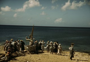 Housewives at the seashore waiting for the fishing boats to come in Frederiksted, V.I., 1941. Creator: Jack Delano.