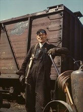 Mike Evans, a welder, at the rip tracks at Proviso yard of the C & NW RR, Chicago, Ill., 1943. Creator: Jack Delano.