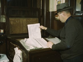 Switch lists coming in by teletype to the hump office at a C& NW RR yard, Chicago, Ill., 1942. Creator: Jack Delano.