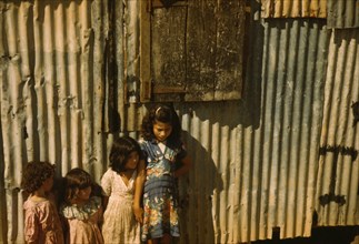 Children in a company housing settlement, Puerto Rico, 1941. Creator: Jack Delano.