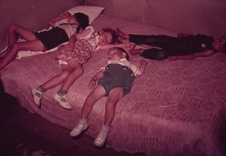 Children asleep on bed during square dance, McIntosh County, Okla., 1939 or 1940. Creator: Russell Lee.