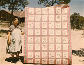 Mrs. Bill Stagg with state quilt that she made, Pie Town, New Mexico. , 1940. Creator: Russell Lee.