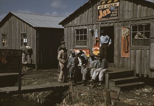 Migratory laborers outside of a "juke joint" during a slack season, Belle Glade, Fla., 1941. Creator: Marion Post Wolcott.