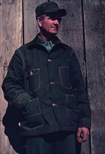 Man in bill cap and dungaree coat, possibly a farmer, between 1941 and 1942. Creator: Unknown.