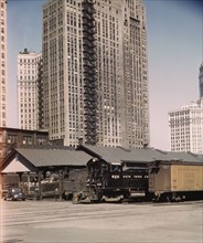 Diesel switch engine moving freight cars at the South water...Illinois Central R.R., Chicago, 1943. Creator: Jack Delano.
