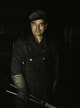 Daniel Anastazia, blacksmith's helper...roundhouse of the Rock Island R.R., Blue Island, Ill., 1943. Creator: Jack Delano.