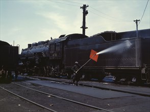 Cleaning an engine near the roundhouse, C. M. St. P. & P. R.R., Bensenville, Ill., 1943. Creator: Jack Delano.