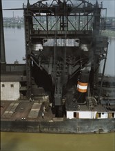 Loading coal into a lake freighter at the Pennsylvania Railroad docks, Sandusky, Ohio, 1943. Creator: Jack Delano.