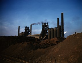 Iron ore piles and blast furnaces, Carnegie-Illinois Steel Corporation mill, Etna, Pa., 1941. Creator: Alfred T Palmer.
