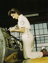 Oyida Peaks riveting as part of her NYA training...Naval Air Base, Corpus Christi, Texas, 1942. Creator: Howard Hollem.