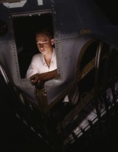 As an NYA trainee working inside the nose of a PBY, Elmer J. Pace...Corpus Christi, Texas, 1942. Creator: Howard Hollem.