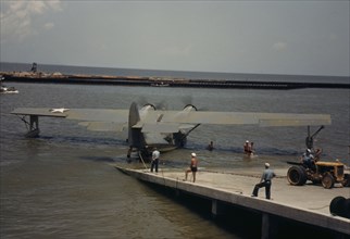 Working with a sea-plane at the Naval Air Base, Corpus Christi, Texas, 1942. Creator: Howard Hollem.