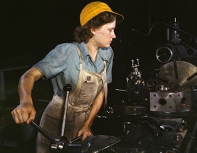 Lathe operator machining parts...Consolidated Aircraft Corporation plant, Fort Worth, TX, 1942. Creator: Howard Hollem.