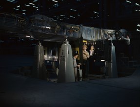 Working on the wing center section at the Consolidated Aircraft Corp..., Fort Worth, Texas, 1942. Creator: Howard Hollem.