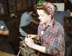 One of the girls of Vilter [Manufacturing] Co. filing small gun parts, Milwaukee, Wisc. , 1943. Creator: Howard Hollem.