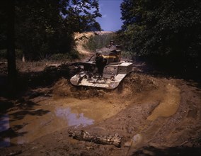Light tank going through water obstacle, Ft. Knox, Ky., 1942. Creator: Alfred T Palmer.