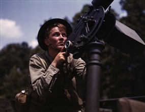 Good man, good gun: a private of the armored forces does some practice..., Fort Knox, Ky., 1942. Creator: Alfred T Palmer.