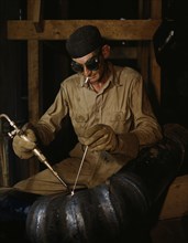 Gas welding a joint in a line...at the TVA's new Douglas Dam on the French Broad River, Tenn., 1942. Creator: Alfred T Palmer.