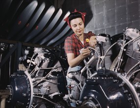 Woman working on an airplane motor at North American Aviation, Inc., plant in Calif., 1942. Creator: Alfred T Palmer.