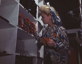 Clerk in one of the stock rooms of North American Aviation, Inc..., Inglewood, Calif. , 1942. Creator: Alfred T Palmer.