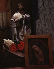 A Santo bulto and a painting of the Dolorosa in the church, Trampas, New Mexico, 1943. Creator: John Collier.