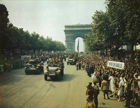 Crowds of French patriots line the Champs Elysees to view Allied tanks and half tracks pass..., 1944 Creator: Jack Downey.