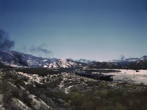 Santa Fe R.R. trains going through Cajon Pass in the San Bernardino Mountains, Cajon, Calif., 1943. Creator: Jack Delano.
