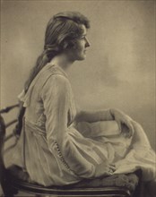 Young woman seated, looking right, 1918.