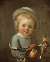 Portrait of a boy holding a puppet.