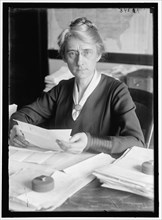 D.E. Thompson, between 1913 and 1918. Woman with paperwork.