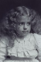 Little girl with fair, wavy hair, c1900.