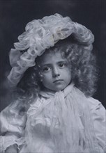 Portrait of little girl in frilly hat, c1900.