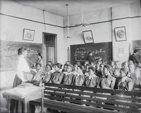 Mathematics class at Tuskegee Institute, 1906. [Young black women learning maths].