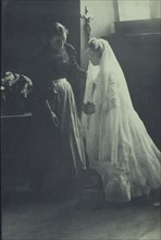 Young woman at her first communion with an attendant, c1900.