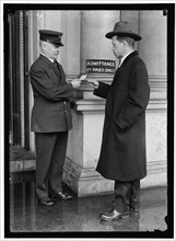 Examining pass at State Department Building, between 1913 and 1918. Creator: Harris & Ewing.