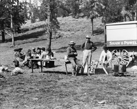 Tourists and guides picnicking in Yellowstone Park, 1903.