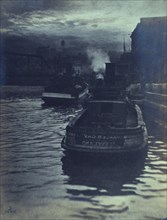 Rear view of tugboats approaching a wharf, possibly in Cleveland, Ohio, 1903.
