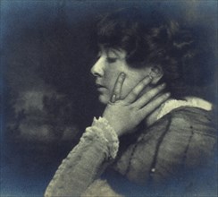 Woman resting her head on her left hand, head-and-shoulders profile portrait, c1900. Creator: Unknown.