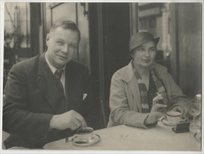 Natalia Goncharova and Mikhail Larionov at the Restaurant Petit Saint-Benoît, 1932. Private Collection.