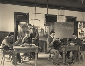 Students constructing telephones at Hampton Institute, 1899 or 1900.
