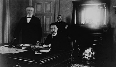 Three Treasury Department employees in office, between 1884 and 1930.