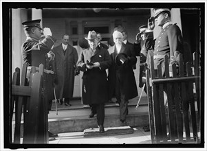 Woodrow Wilson descending steps with unidentified persons, between 1910 and 1917.