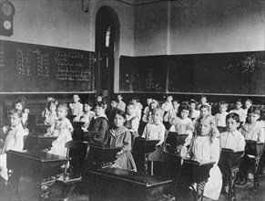 Girls and boys seated at desks in classroom, Washington, D.C., (1899?).