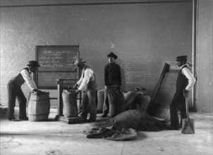 Four young men mixing fertilizers, Hampton Institute, Hampton, Va., 1899 or 1900.
