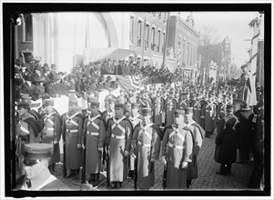 Parade with President Woodrow Wilson and Mrs. Wilson on reviewing stand, between 1910 and 1914.