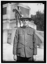 Young man in uniform standing in front of Sherman Monument, Washington, D.C., between 1916 and 1918.
