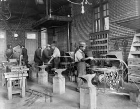 Young men training in blacksmithing at Hampton Institute, Hampton, Virginia, 1899 or 1900.