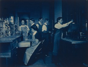 Students conducting experiments in laboratory, Western High School, Washington, D.C., (1899?).