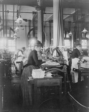 Women operating machinery at the Bureau of Printing and Engraving, Washington, D.C., 1889 or 1890.